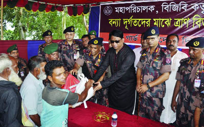 DINAJPUR: Whip of the Jatiya Sangsad Iqbalur Rahim MP and DG of BGB Maj Gen Abul Hossain distributing relief goods at Kamdevpur in Biral Upazila on Thursday.