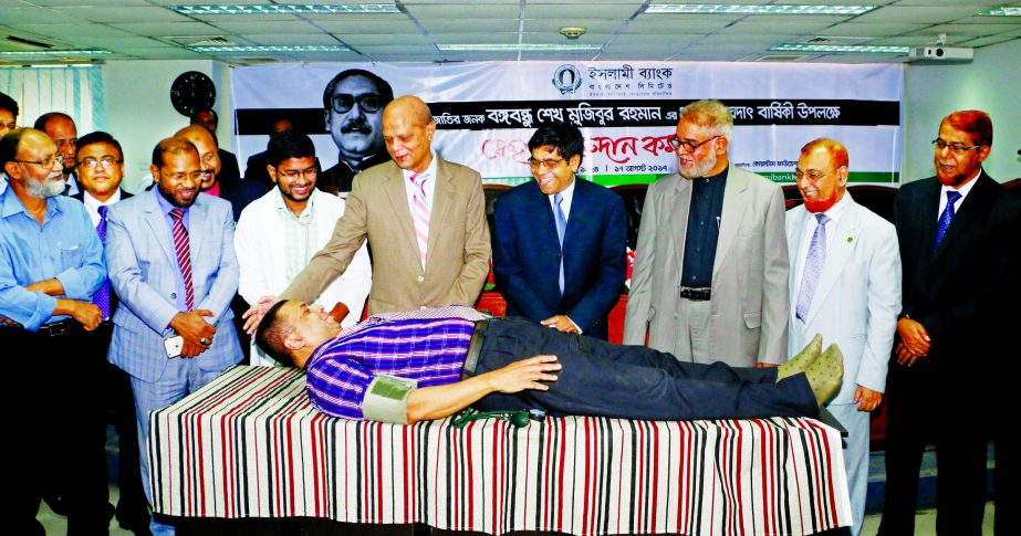 Arastoo Khan, Chairman of Islami Bank Bangladesh Limited, inaugurating a voluntary blood donation programme on the occasion of National Mourning Day at the banks head office in the city on Thursday. Md. Joynal Abedin, Director and Md. Abdul Hamid Miah, Ma