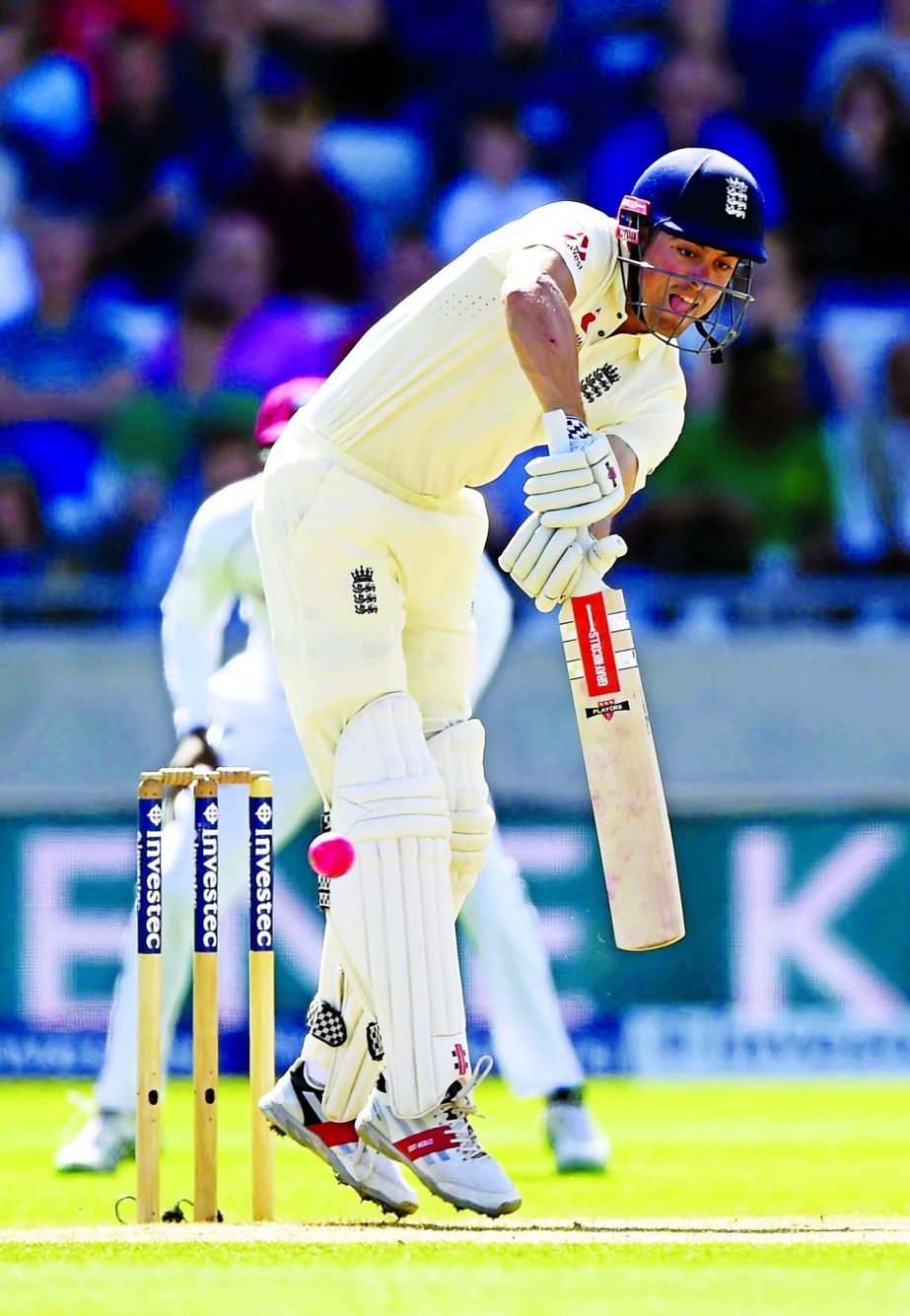 England's Alastair Cook defends his wicket during day one of the England versus the West Indies First Test cricket match at Edgbaston, Birmingham, central England on Thursday.