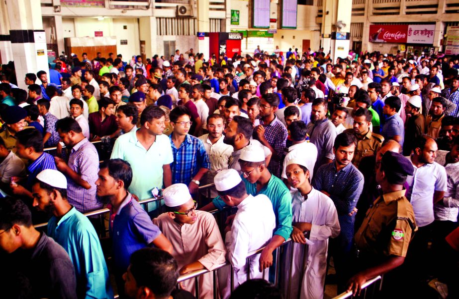 Thousands of people waiting in queue at Kamalapur Railway Station Counter to buy advance tickets on Friday.