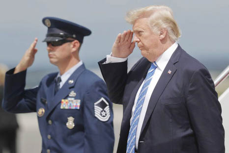 President Donald Trump returns a salute upon his arrival at Hagerstown Regional Airport in Hagerstown, Md., on Air Force One on Friday, en route to nearby Camp David, for a meeting with his national security team to discuss strategy for South Asia, includ