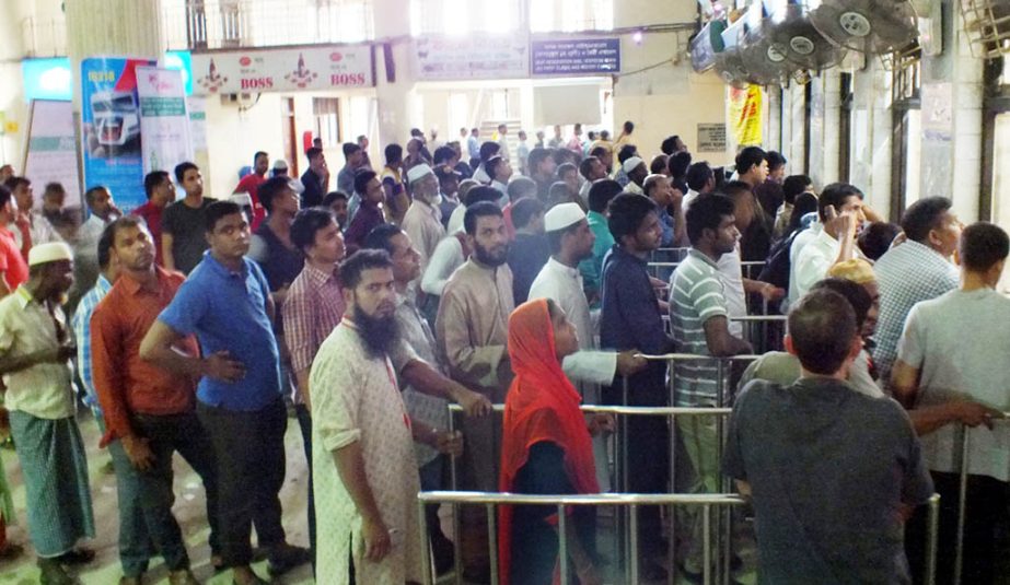 People waiting in a long queue at Chittagong Rail Station for Eid advance rail tickets on Friday.