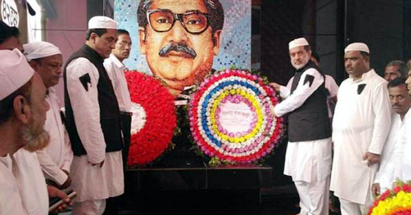 Chairman of the Parliamentary Standing Committee on Ministry of Railway ABM Fazle Karim Chowdhury seen placing wreath at the portrait of Father of the Nation Bangabandhu to mark the 42th Martyrdom Anniversary of Bangabandhu at Raozan upazila square o
