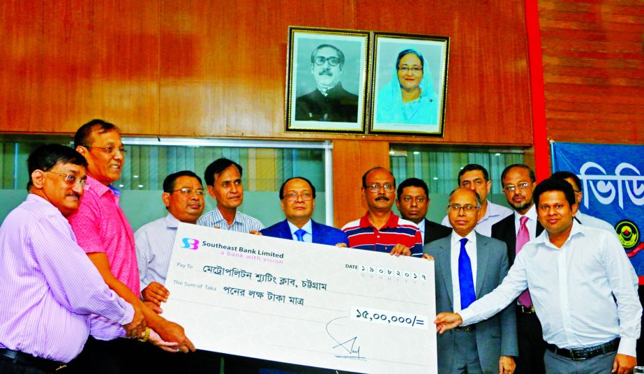 M Kamal Hossain, Managing Director of Southeast Bank Limited, handing over a cheque of Tk 1.5 million to Md. Iqbal Bahar, Police Commissioner and President of Metropolitan Shooting Club, Chittagong at CMP head quarter on Saturday. High officials from both