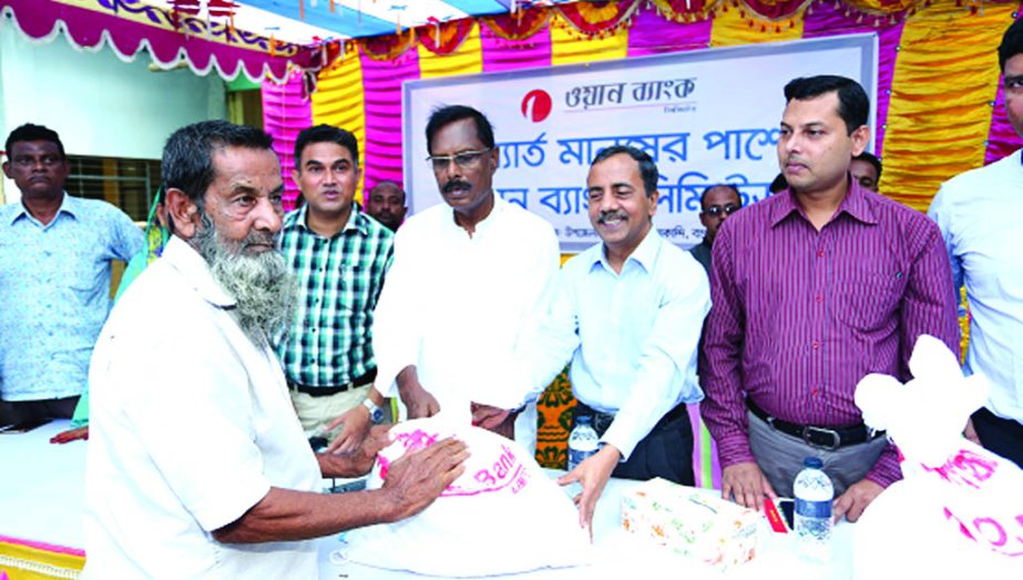 Abdul Mannan, MP of Bogra-1 constituency, distributing relief goods among the flood affected people of different Unions of Sariakandi Upazila under the district recently arranged by ONE Bank Limited. Wakar Hasan, DMD of the bank and Md. Moniruzzaman, Sari