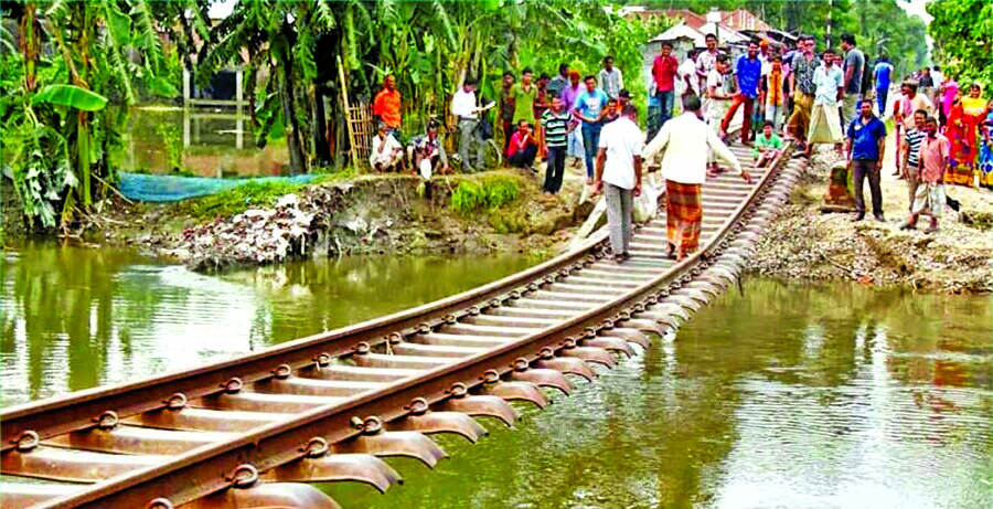 Train services between Lalmonirhat and Burimari land port remains suspended since Saturday as upstream floodwater washed away railway trackbed at the Medical Crossing in Hatibandha Upazila of the district. This photo was taken on Sunday.