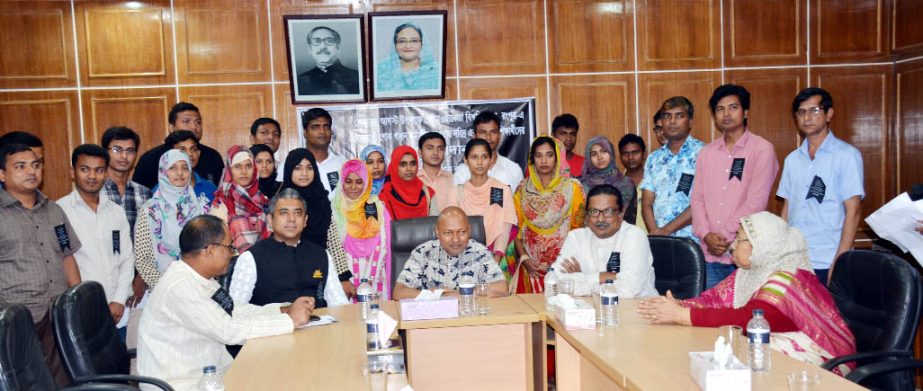 Prof Dr Nazmul Ahsan Kalimullah, BTFO, Vice Chancellor of Begum Rokeya University, Rangpur is seen with twenty recipients of a token scholarship distribution programme held on the University Campus on Saturday under the University's month-long programme
