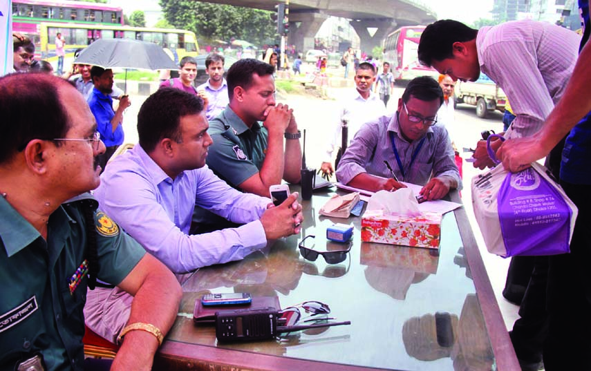 A mobile court of DMP realized Tk 100 per head for not using foot-over bridge for crossing road. The snap was taken from the city's Mohakhali on Monday.