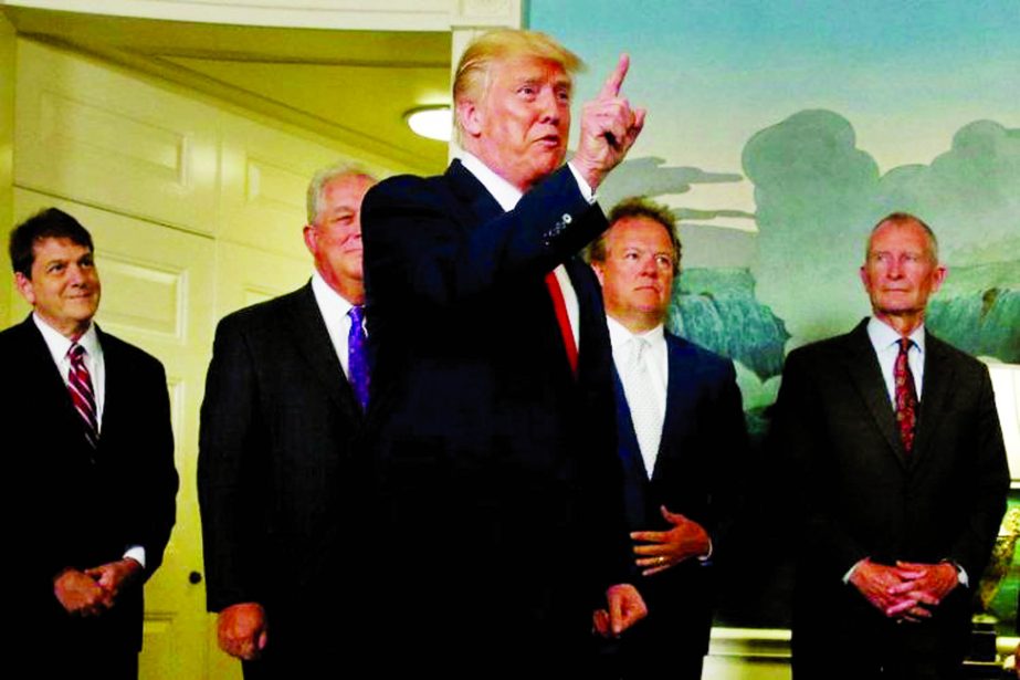 US President Donald Trump responds to a reporter's question after signing a memorandum at the White House in Washington, US.