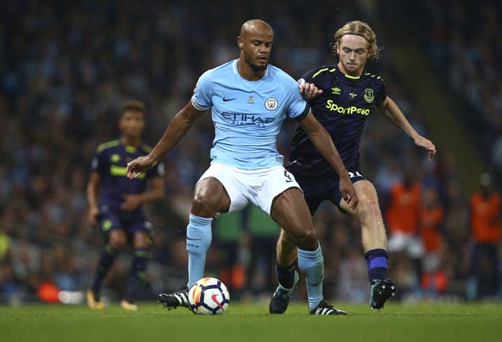 Manchester City's Vincent Kompany (left) and Everton's Tom Davies battle for the ball during the English Premier League soccer match between Manchester City and Everton at the Etihad Stadium in Manchester, England on Monday.
