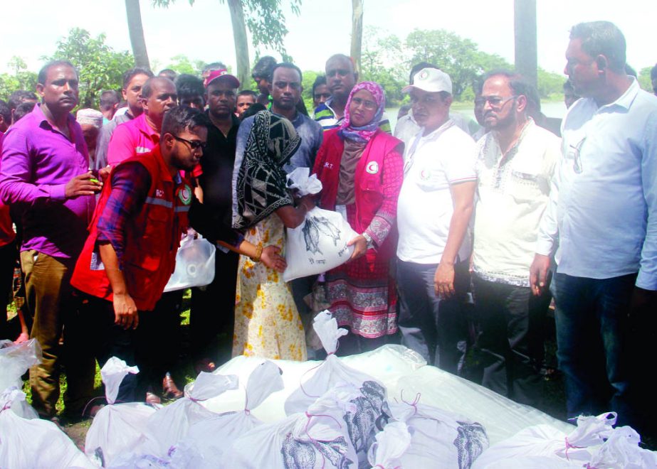 SYLHET: Bangladesh Red Crescent Society, Sylhet District Unit distributing relief materials among the flood -hit people at Khadimnagar Union recently.