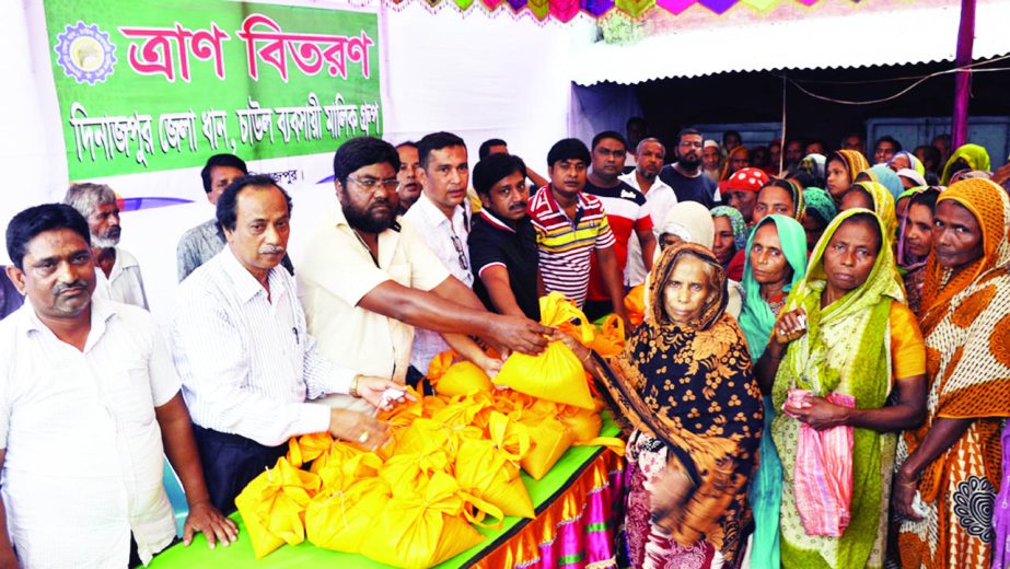 DINAJPUR: Md Mosarraf Hossain, Convener, Dinajpur District Dhan, Chal Bapshahi Malik Group distributing relief goods among the flooded people at Pulhat point on Tuesday.