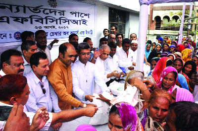 DINAJPUR: FBCCI distributing relief goods among the floodhit people at Dinajpur Chamber premises on Wednesday.