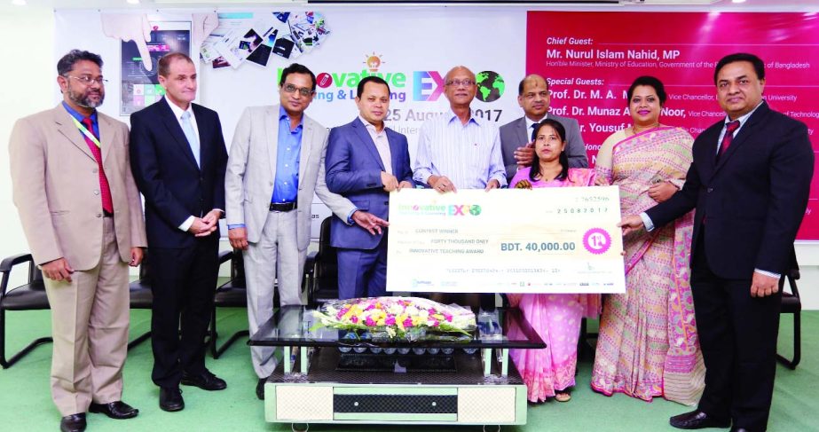 Education Minister Nurul Islam Nahid handing over champion award to Ms. Latifa Akter Sheuly, Headmistress of Dalnia High School under Gopalganj district for her best innovative teaching project submission in the Innovative Teaching and Learning Expo 2017