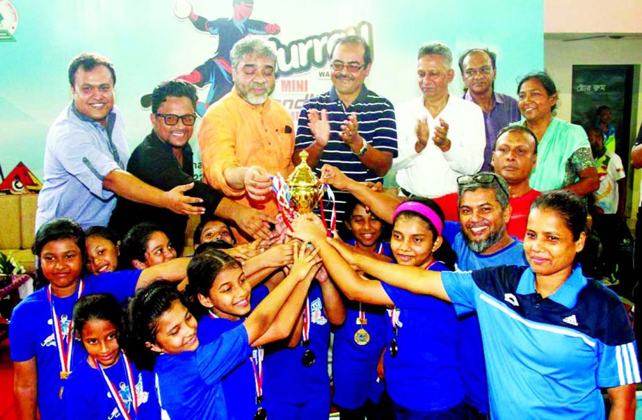 Members of Sunnydale, the champions of the Girls' Division of the Hurrah Mini School Handball Tournament with the officials and guests of Bangladesh Handball Federation pose for a photo session at the Shaheed (Captain) M Mansur Ali National Handball Sta