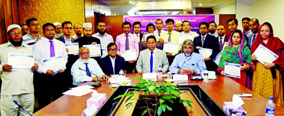 Major (Retd.) Dr. Md. Rezaul Haque, Chairman of Social Islami Bank Limited, poses with the participants of a daylong training programme on ''National Integrity Strategy & Ethics in Islamic Banking" arranged by IBCF Research & Training Academy arranged