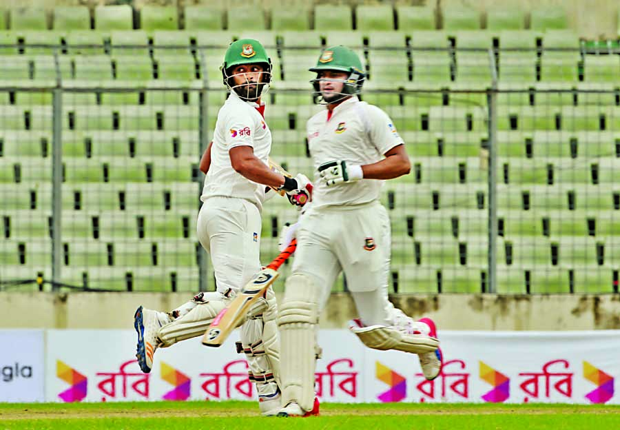 Shakib Al Hasan (right) and Tamim Iqbal running between wicket during the 1st day play of the 1st Test between Bangladesh and Australia at the Sher-e-Bangla National Cricket Stadium in the city's Mirpur on Sunday.