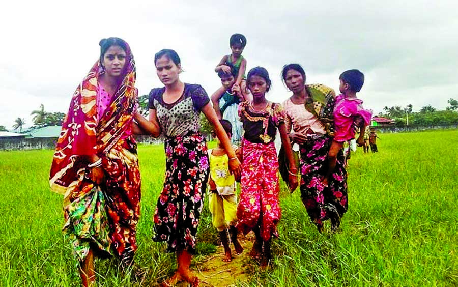 Women and children fleeing violence in their villages arrive at the Yathae Taung township in Rakhine State in Myanmar on Saturday.