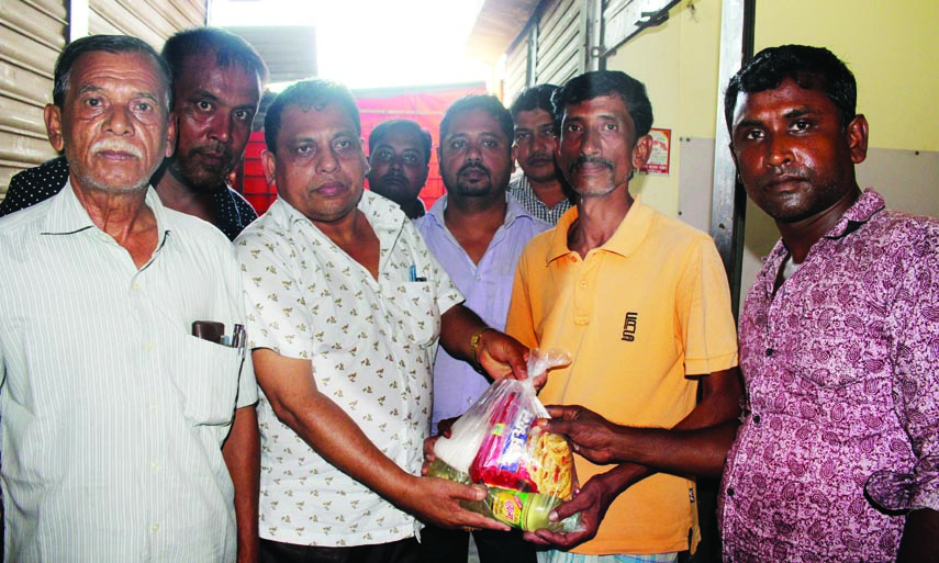 Vice-President of Dhaka Divisional Deed Writers Association Mosharaf Hossain Mridha and Chairman of Bangladesh Human Rights and Press Society Anwar Hossain Akash distributing Eid items among the poor people in front of Mariam office in Kapasia upazila on