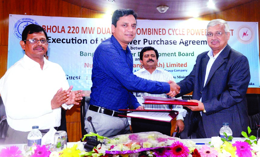 J Sinha Mahapatra, Director, Nutan Bidyut Bangladesh Ltd handing over documents to Quazi Mohammad Hasan, Secretary, Bangladesh Petroleum Corporation (BPC) at a power purchase agreement (PPA) at Bidyut Bhaban in the city yesterday. Power Development