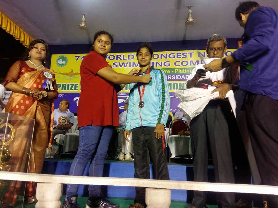 Nazma Khatun of Bangladesh Navy receiving the silver medal at Murshidabad in West Bengal of India on Sunday. Nazma Khatun achieved the second position in the 19 km long distance event of the 74th World Long Distance Swimming Competition.