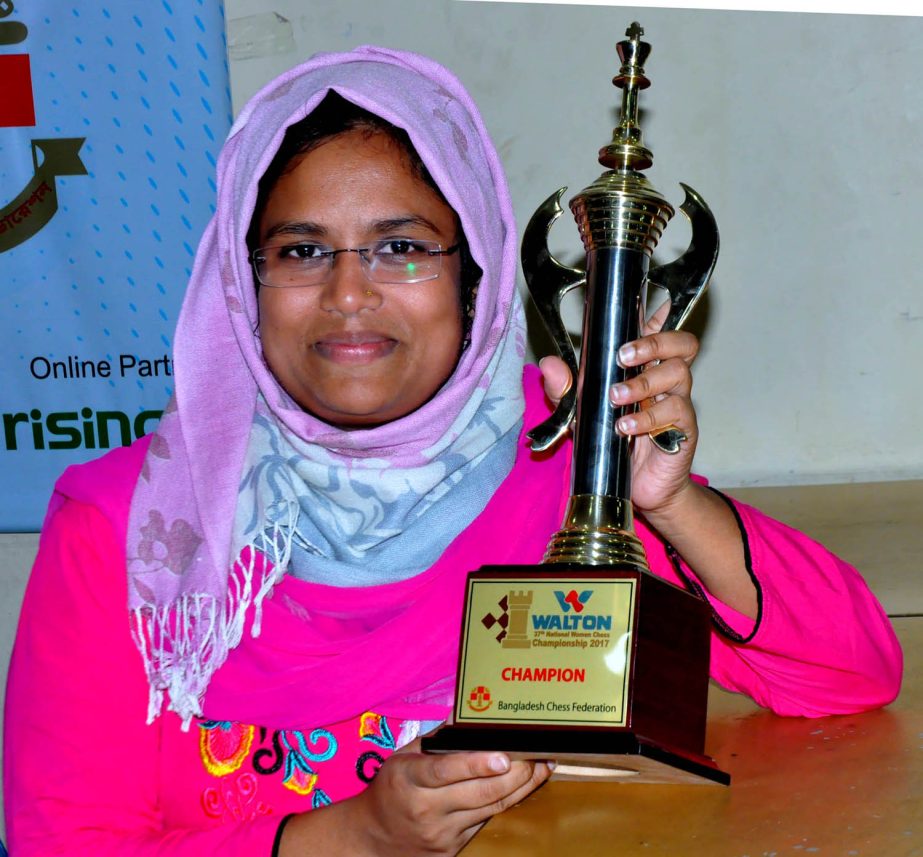 Woman FIDE Master Sharmin Sultana, the champion of the Walton 37th National Women's Chess Championship pose with the trophy at Bangladesh Chess Federation hall-room on Monday.