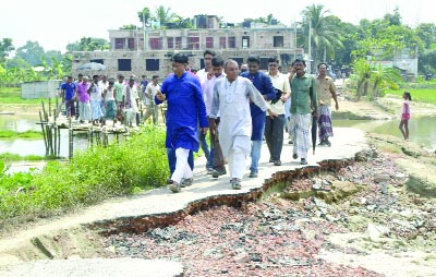 DINAJPUR: Whip of Parliament Iqbalur Rahim MP visiting damaged roads and bridges at Kornai Village on Saturday.