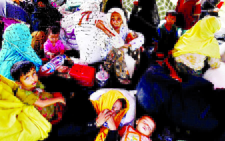 Rohingya people sit in a makeshift shelter on Monday near the Bangladesh-Myanmar border as they are being restricted by Bangladesh in Cox's Bazar on Sunday.
