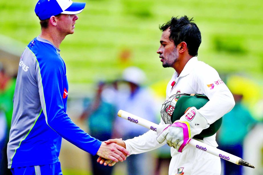 Bangladesh's cricket team captain Mushfiqur Rahim (right) shakes hand with Australian cricket team captain Steve Smith at the end of the fourth day of their first Test cricket match at Sher-e-Bangla National Cricket Stadium in Mirpur on Wednesday.