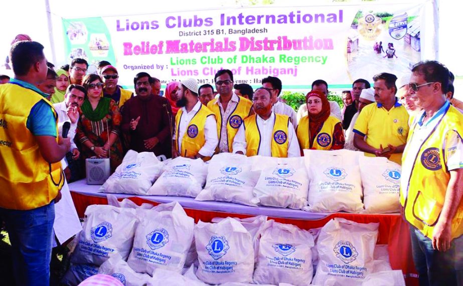 HABIGANJ: Lions Club of Habiganj, Dhaka Regency distributing relief goods among the flood -hit people at Habiganj recently.