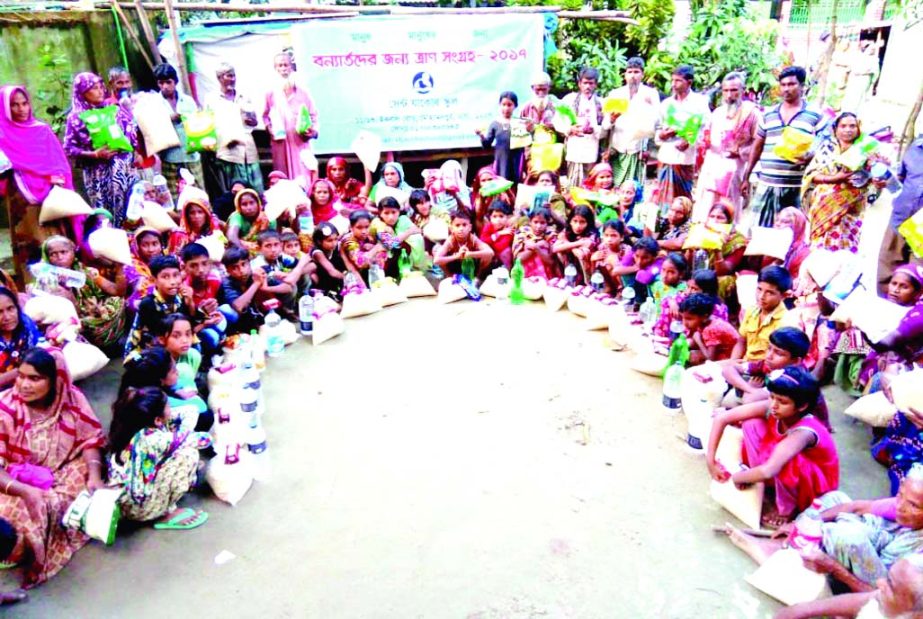 MANIKGANJ: Sudents and teachers of Saint Josef School , Dhaka distributed relief goods among the flood affected people at Daulatpur Upazila on Sunday.