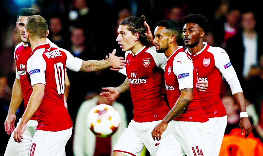 Arsenal's Hector Bellerin (center) celebrates with teammates after scoring during the Europa League group H soccer match between Arsenal and FC Cologne at the Emirates stadium in London, England on Thursday .