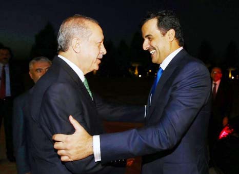 Qatari Sheikh Tamim bin Hamad al-Thani greets Turkish President Recep Tayyip Erdogan at the presidential complex in Ankara.