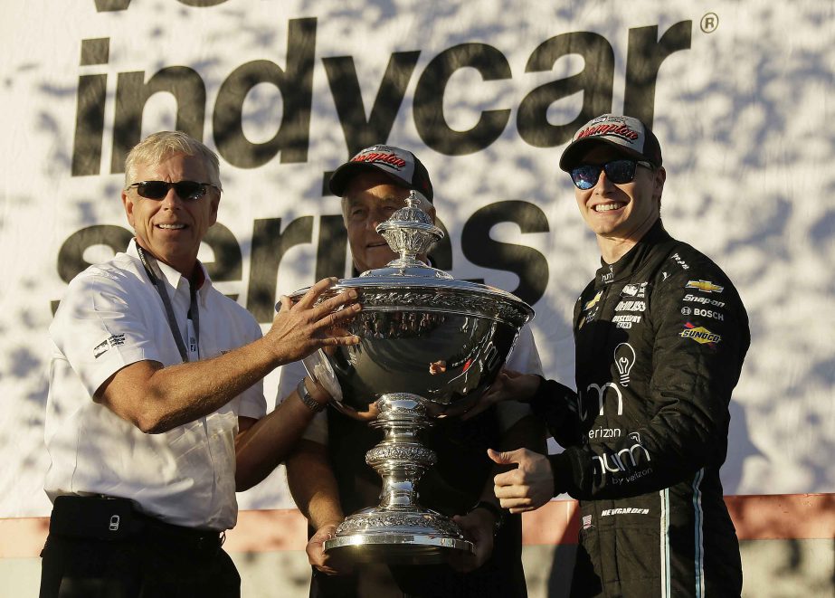 Josef Newgarden, (right), stands and celebrates after being presented the Astor Cup for winning the IndyCar championship in Sonoma, Calif. Looking on at center is team owner Roger Penske on Sunday.