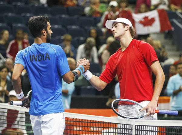 Canada's Brayden Schnur (right) and India's Yuki Bhambri shake hands after the match during Davis Cup singles tennis tournament action in Edmonton, Alberta on Sunday.