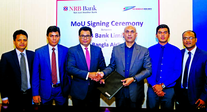 Imran Ahmed FCA, Chief Operating Officer of NRB Bank Limited and Sohail Majid, Deputy Director of Sales and Marketing of US-Bangla Airlines, exchanging an agreement signing document at the bank's head office on Tuesday. Under the agreement, the bank cred