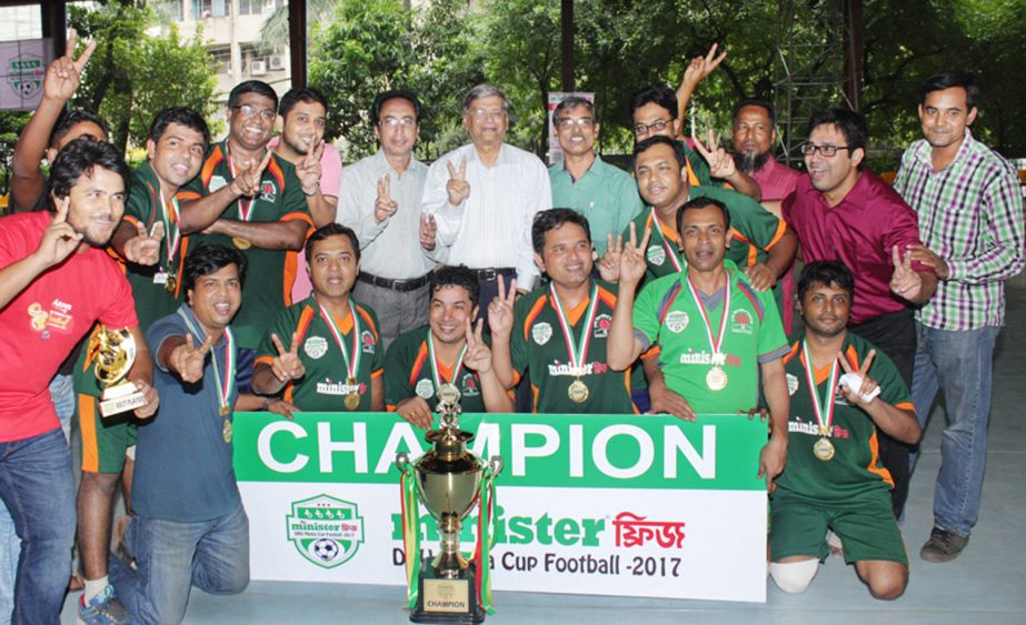 Members of Bangla Vision, the champions of the Minister Fridge-DRU Media Cup Football Tournament with the guests and officials of DRU pose for a photo session at the Shaheed (Captain) M Mansur Ali National Handball Stadium on Tuesday.