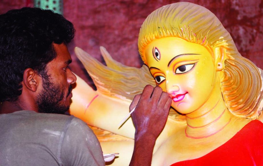 An artist giving final touch to 'Godess' as Durga Puja is coming to nearer. This picture was taken from Zamindar Bari Mondir in Banglabazar area in the city yesterday.