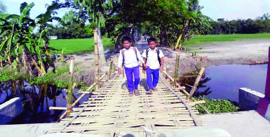 SUNDARGANJ (Gaibandha): People are using bamboo made bridge at the damaged portion of Ram Dakuya - Panchanoth Bridge in Sundarganj Upazila which needs immediate repair. This snap was taken on Tuesday.