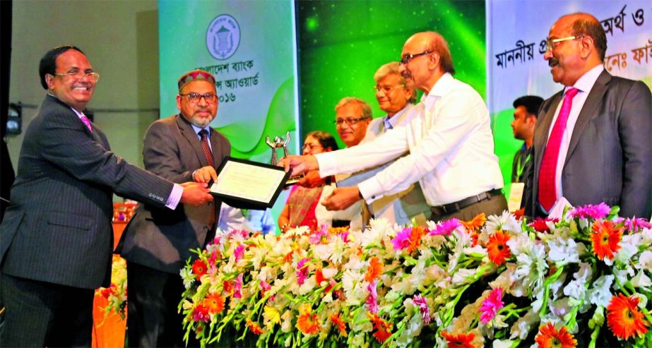 Fazle Kabir, Governor of the Bangladesh Bank and MA Mannan, State Minister for Finance and Planning, handing over "Remittance Award 2016" to Md Abdus Salam, Managing Director of Janata Bank at Bangla Academy conference hall on Tuesday. Md. Eunusur Rahma