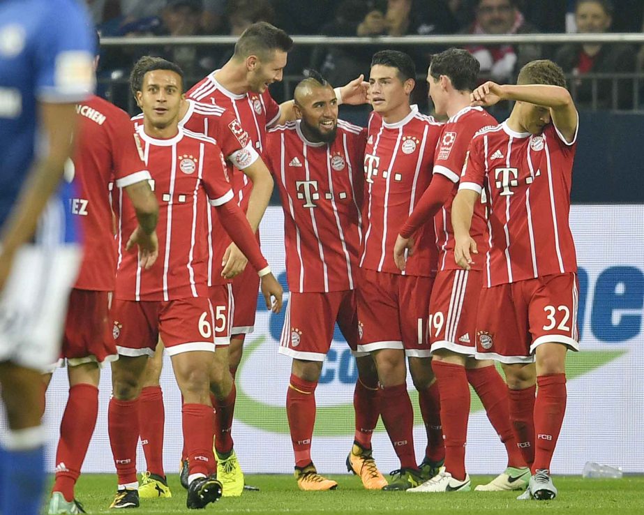 Bayern's Arturo Vidal is celebrated after he scored the third goal for Bayern during the German Bundesliga soccer match between FC Schalke 04 and Bayern Munich at the Arena in Gelsenkirchen, Germany on Tuesday.