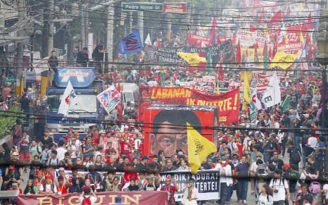 Hundreds of protesters march towards a Manila park for a rally to call for an end to the killings in the so-called war on drugs of President Rodrigo Duterte and his alleged "tyrannical rule"" of the country on Thursday."