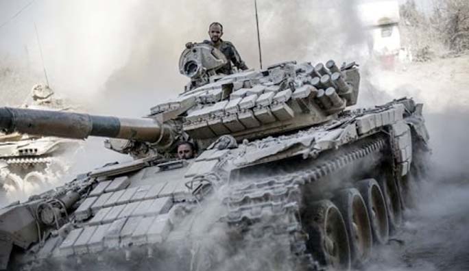 A fighter from Syrian Democratic Forces (SDF) sits in a military tank in Raqqa.