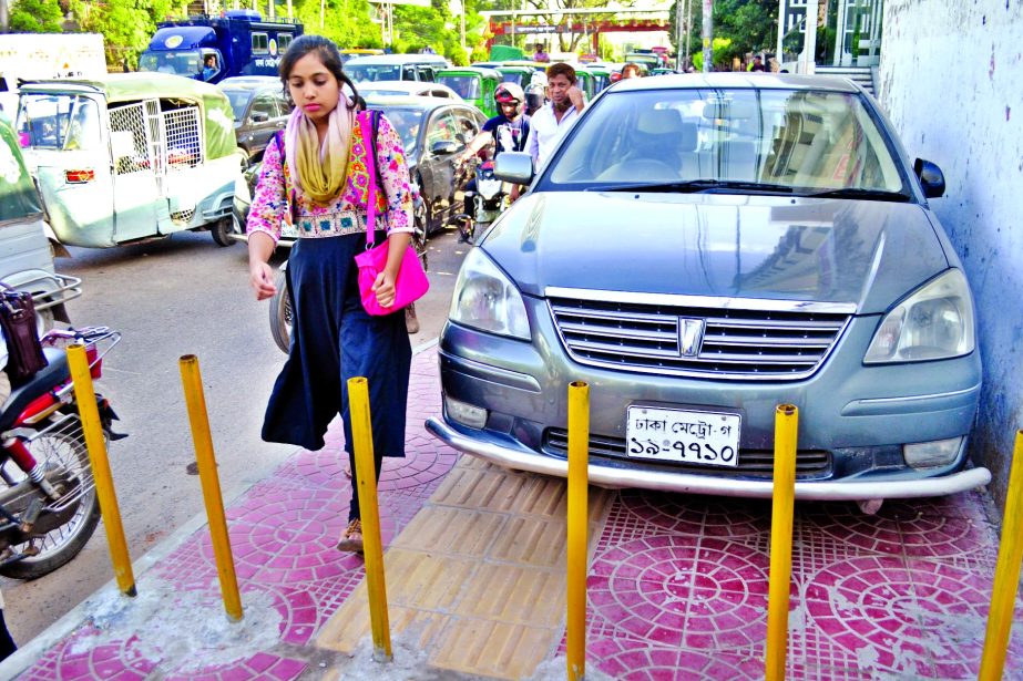 A motorized vehicle parked illegally at a point near the pipe barricade installed by DMP creating obstacle for pedestrians. The snap was taken from the city's Bangla Motor area on Thursday.