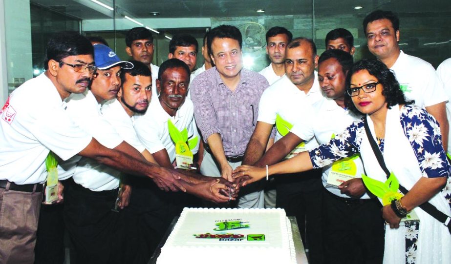 Shahin Khan, CEO of Jemcon Food and Agricultural Products Limited, inaugurating the 15th anniversary programme of Meenabazar by cutting a cake on Friday in the city. High officials of the company were also present.