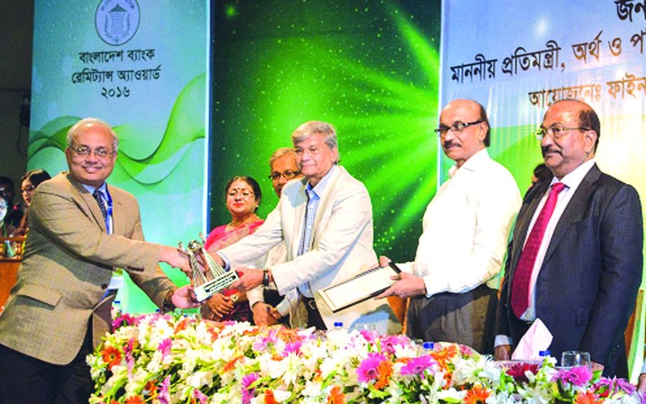 Mohammad Shams-Ul Islam, Managing Director of Agrani Bank Limited, receiving the "Bangladesh Bank Remittance Award -2016" from State Minister for Finance and Planning M A Mannan, MP, at a city auditorium on Tuesday. The bank is honored as the Highest R