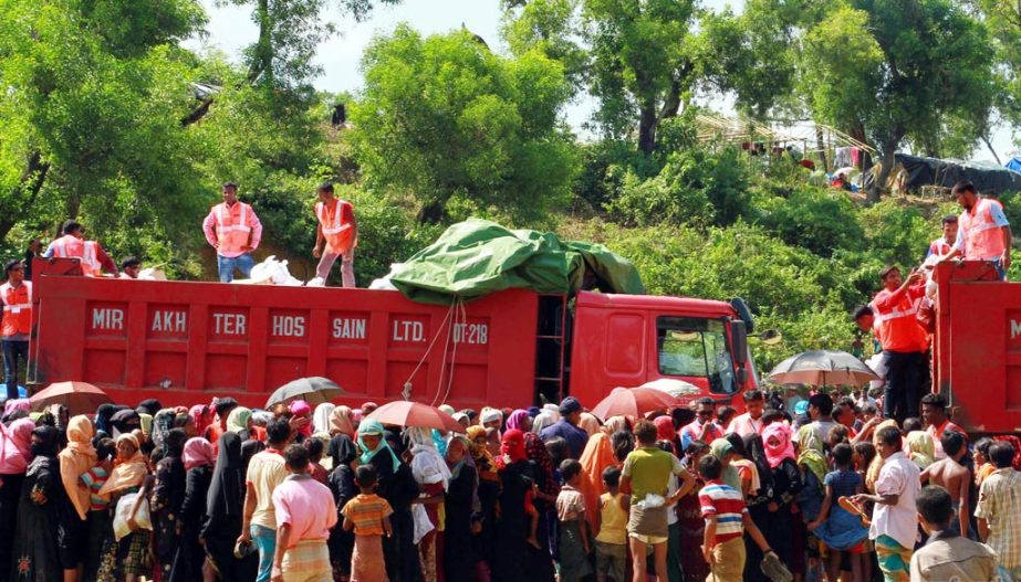 Rohingya people at Balukhali refugee camp rushing for relief on Friday.