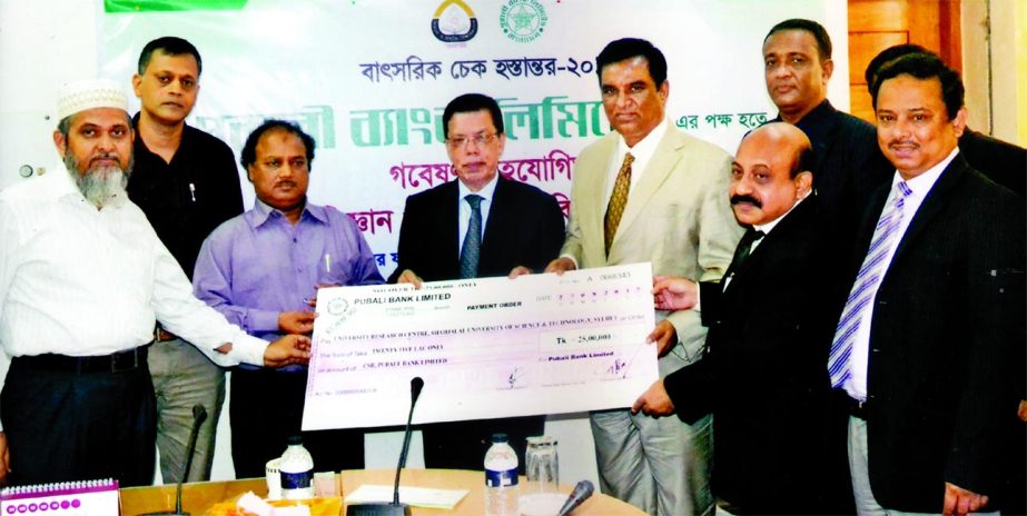 Md. Abdul Halim Chowdhury, Managing Director of Pubali Bank Limited, handing over a cheque of Tk 25 lakh to Professor Farid Uddin Ahmed, Vice Chancellor of Shahjalal University of Science and Technology for its Research Centre at VC office recently. Profe