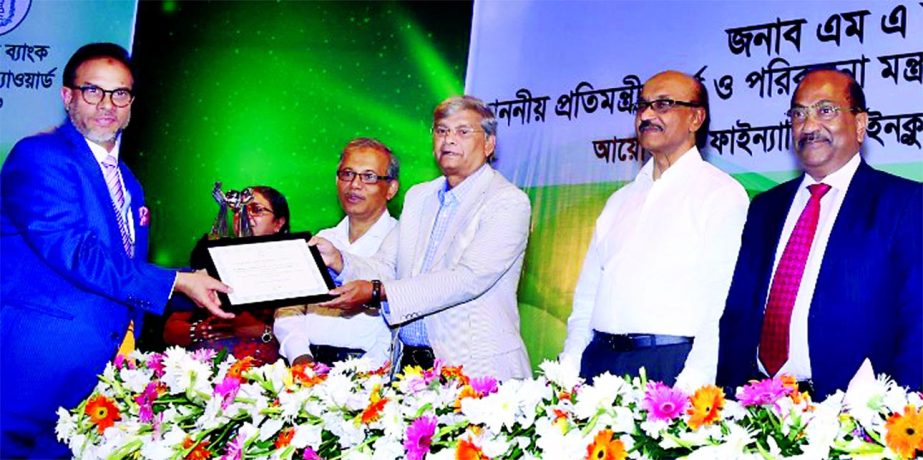 Mohammed Mahtabur Rahman, Chairman of Al Haramain Perfumes Group of Companies and Chairman of NRB Bank Limited, receiving the Bangladesh Bank Remittance Award-2016 from State Minister for Finance and Planning MA Mannan at a city auditorium in the city on