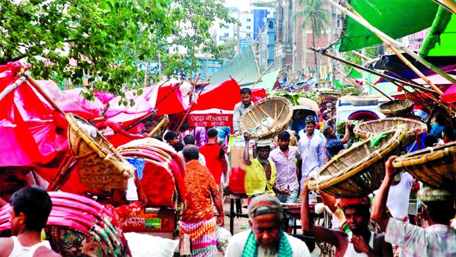 A busy road in city's Farashganj area totally occupied illegally by some unscrupulous traders hindering vehicular movement causing sufferings to the local people. This picture was taken on Monday.